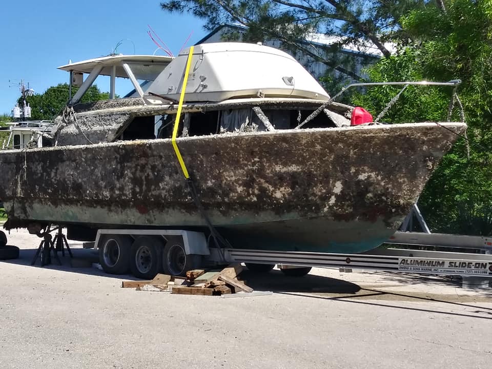 Weathered recovered hull supported ashore