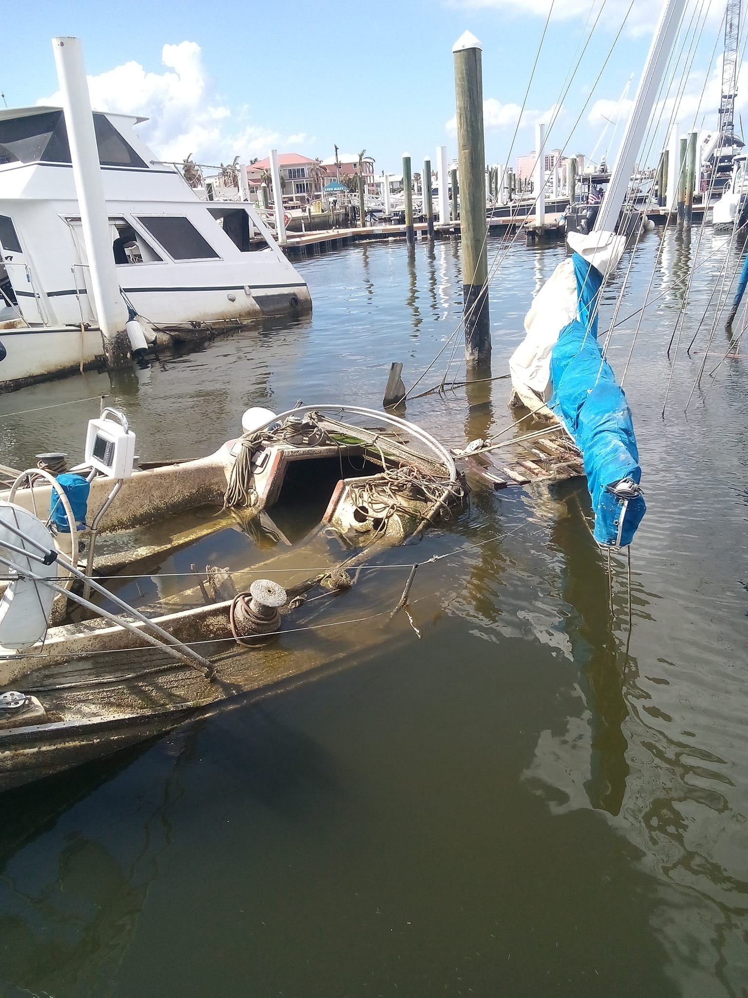 Submerged sailboat cockpit at a marina