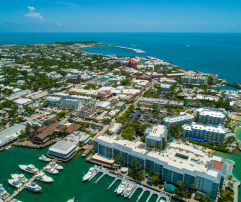Boats docked at Key West Harbor with clear blue water and sky