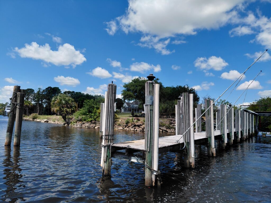 Wooden dock and tall pilings along a waterway