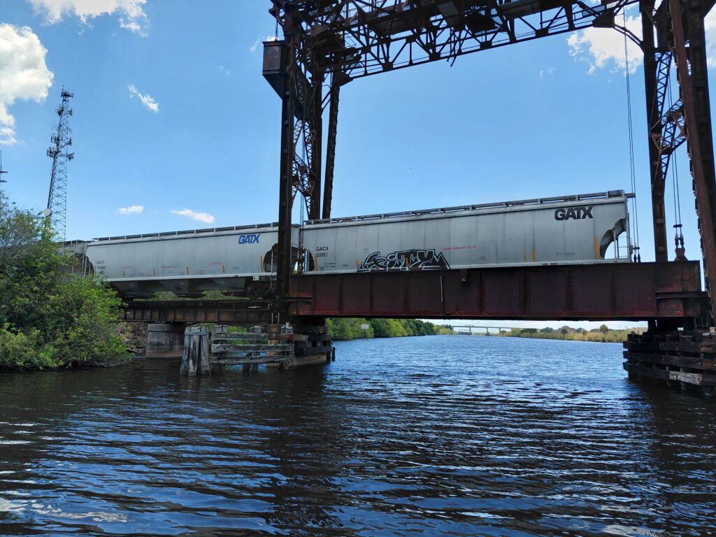 Railway bridge crossing a waterway, viewed from the water