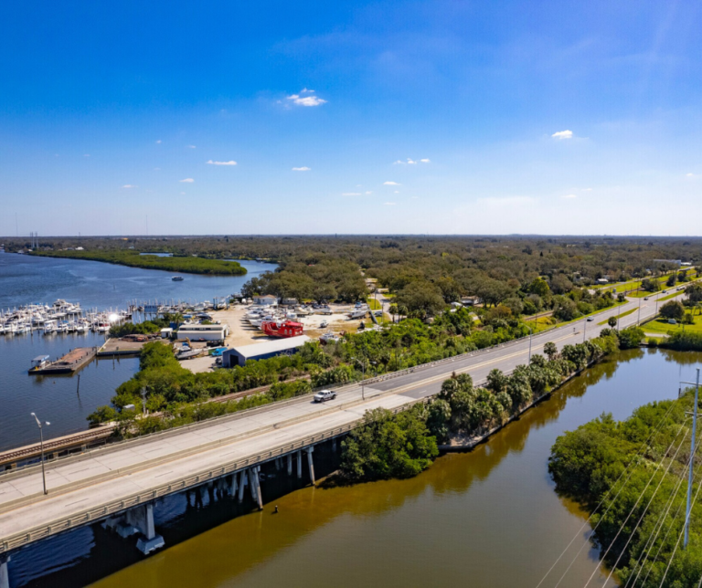 Gibsonton bridge spanning the Alafia River with boats passing underneath in Florida.